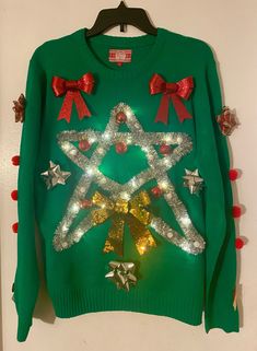 a green sweater with lights and bows on it