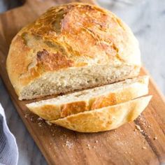 a loaf of bread sitting on top of a wooden cutting board