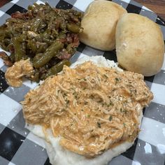 a plate topped with potatoes, green beans and pulled pork on top of mashed potatoes