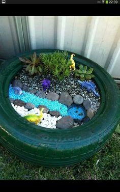 a tire planter filled with rocks and plants