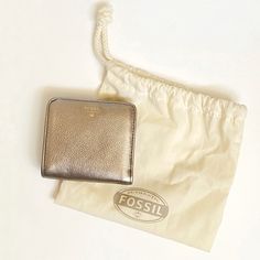 Fossil Sydney Bifold Wallet In Silver Metallic ( I Think Its More Of A Rose Gold / Bronze Color ) Genuine Cow Hide Leather 7 Slip Pockets A Clear Plastic Pocket For Id Single Snap Button Closure Small Exterior Written Logo Nwt - New With Tags Aprox Measurements : 3.75” X 3.5” Open: 3.75” X 6.75” The Perfect Wallet If You Like Mini/Small Bags Out My Closet! Bundle & Save! New To Poshmark? Use My Closet Name Drewsula123 As The Referral Code When You Sign Up And Get 10% Off! Tags: All Solid Plain T Everyday Gold Leather Coin Purse, Gold Bifold Wallet For Everyday Use, Gold Leather Bifold Bag, Gold Bifold Leather Bag, Chic Gold Bifold Wallet, Chic Gold Wallet For Everyday Use, Chic Gold Wallets For Everyday Use, Elegant Everyday Gold Coin Purse, Gold Coin Purse For Everyday Use