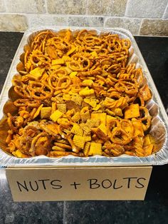 a container filled with nuts and bolts on top of a table