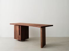 a wooden table sitting on top of a white floor