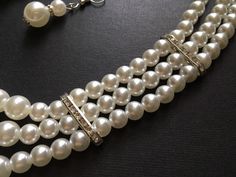 "This pearls necklace is soooo romantic and beautiful which you (and me) can deny of it!! Very vintage Victorian style with a simple design pendant set on one side and linked to 3 rows pearls chain. We have added an extra long cable chain finished with a sparkle pendant at end for you to adjust the length. Size: necklace measures around 20\" long (inner) x 24.25\" (outside) width. Earring 1.75\" drop x 0.4\" width Color: silver with clear/black rhinestone crystals, glass stones and pearls ** Ple Elegant Multi-strand Pearl Layered Necklace, Modern Pearl Necklace, Luxury Multi-strand Pearl Necklace For Wedding, Luxury Multi-strand Pearl Necklace For Party, Luxury Silver Multi-strand Pearl Necklace, Vintage Multi-strand Pearl Necklace For Formal Occasions, Rhinestone Headpiece, Bridal Pearl Necklace, Crystal Headpiece