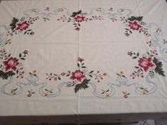 a white table cloth with pink flowers on it