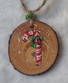 a wooden ornament with a candy cane on it