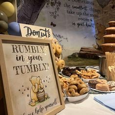 a winnie the pooh themed birthday party with donuts and other treats on display