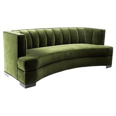 a green curved couch sitting on top of a white floor