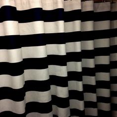 black and white striped shower curtain in bathroom