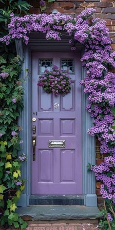 a purple door surrounded by flowers and greenery