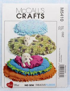 the sewing pattern has three pillows and two small dogs on top of each pillow, one is