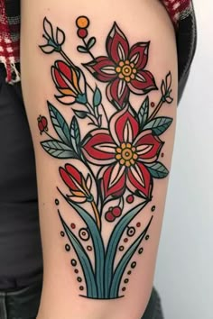 a woman's arm with flowers and leaves tattooed on the left side of her body