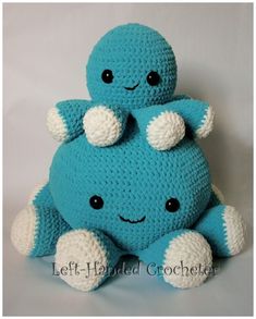 a blue crocheted stuffed animal with two smaller ones on it's back