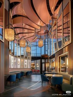 the inside of a restaurant with many tables and chairs, lights hanging from the ceiling