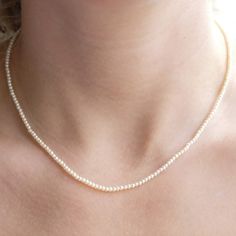 Item Details: Necklace can be ordered in 16" or 18" long. Strand of 2mm freshwater seed pearls. 14K gold spring clasp. Please allow 1 week for production and delivery. Classic Akoya Pearl Necklace With Delicate Chain, Minimalist Single Strand White Gold Pearl Necklace, Classic Single Strand Sterling Silver Pearl Necklace, Classic Round Pearl Necklace With Delicate Chain, Classic Sterling Silver Single Strand Pearl Necklace, Classic Pearl Necklace With Delicate Chain, Classic Pearl White Necklace With Delicate Chain, Dainty White Gold Single Strand Pearl Necklace, Minimalist White Gold Single Strand Pearl Necklace