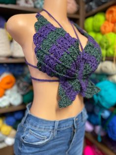 The purple and green are acrylic, soft yarn, and the rainbow is a soft cotton yarn both of these tops are the same size and can fit medium to large. You are getting one top for $35. Purple Crochet Tops For Beach, Purple Crochet Tops For The Beach, Green Knitted Bohemian Tops, Casual Purple Crochet Top, One Size Purple Top For Spring, Purple Crochet Tops For Spring, Spring Purple Crochet Tops, Summer Purple Knitted Tops, Handmade Fitted Green Tops