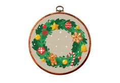 a cross stitch christmas wreath ornament hanging from a wooden hoop on a white background