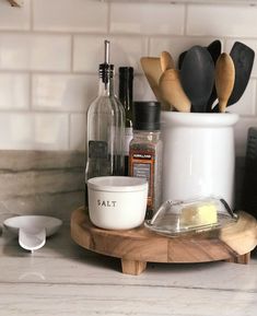 kitchen utensils are sitting on a wooden tray