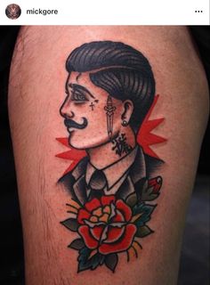 a man with a mustache and flower tattoo on his leg