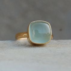 Cushion Aqua Chalcedony 925 Sterling Silver Ring, Natural Chalcedony 18K Rose Gold, 18K Yellow Gold Ring, Statement Gift jewelry Gemstone :  Chalcedony Stone Size :  12  mm Ring Size : Please Choose Your Size stone  Color : Aqua Material :  Please choose your metal It's a unique gift for anyone zodiac style ring . Please Notice before checkout :- Due to we use natural stones, the stones may vary slightly in shape, size and color. Contact us for any other gemstone customization before checkout. W Chalcedony Yellow Gold Jewelry For Anniversary, Yellow Gold Chalcedony Jewelry For Anniversary, Anniversary Yellow Gold Chalcedony Jewelry, Yellow Gold Chalcedony Jewelry Gift, Fine Jewelry In Yellow Gold With Chalcedony, Formal Yellow Gold Chalcedony Jewelry, Gold Chalcedony Jewelry For Anniversary, Yellow Gold Chalcedony Ring Gift, Chalcedony Cabochon Yellow Gold Jewelry