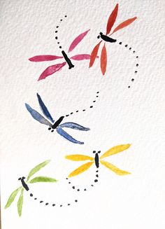 watercolor dragonflys on white paper with black dots in the middle and red, yellow, green, blue, and orange colors