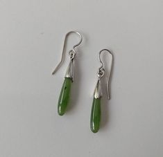 Drop shape Canadian Jade delicate earrings. Genuine nephrite stone earrings. Delicate short green stone earrings. Nice quality natural Canadian Jade from B.C. and sterling silver. Total length with closer is 3,5 cm. Each pair comes with security backings and a nice little bag ready for gift. Teardrop Jade Earrings With Natural Stones, Minimalist Green Teardrop Earrings, Green Pierced Drop Earrings, Green Drop Earrings, Pierced, Green Stone Earrings, Nephrite Jade, Jade Stone, Delicate Earrings, Green Stone