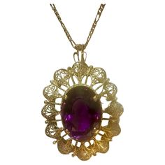 Approximately 23 Carat Amethyst Pendant in 18 Karat yellow gold with 14 Karat Yellow Gold Chain Necklace Vintage This spectacular Pendant Necklace consisting of a single large Oval Cut Amethyst , approximately 23 Carat. The Amethyst is surrounded by a intricate design of gold frame. 18 Karat gold 20 Grams with stone 14 Karat yellow gold chain is 3.8 gm The pendant comes with a 14 Karat Yellow gold Chain length of the 18 Inch Cut: Oval Pendent height approximately 2.5 inches pendent width approximately 1.5 inch Color of the amethyst is Very Pretty, very desirable I did not take professional pictures, all pictures are from my phone. Actual piece is prettier as my phone pictures can not do justice with the item. It's an Estate piece so all measurements and Weight of the stones are approximate Formal Purple Oval Cabochon Jewelry, Formal Yellow Gold Amethyst Necklace, Formal Amethyst Oval Cabochon Jewelry, Formal Amethyst Jewelry, Oval Cabochon, Exquisite Oval Necklace With Large Pendant, Exquisite Oval Large Pendant Jewelry, Exquisite Oval Filigree Necklace, Oval Filigree Necklaces For Formal Occasions, Formal Oval Filigree Necklace