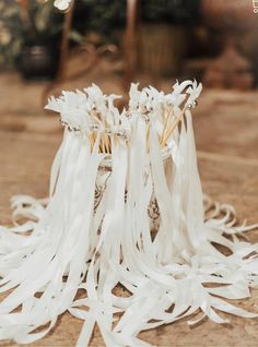 two white wedding garters sitting on the ground