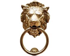 a gold lion head door knocket with a ring on it's side, against a white background