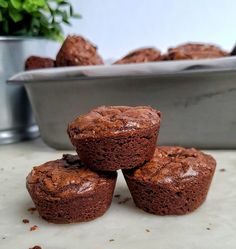 four chocolate muffins sitting on top of a counter