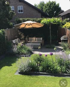 an outdoor patio with seating and umbrella in the middle