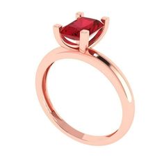 a rose gold engagement ring with a square shaped red stone in the center, on a white background