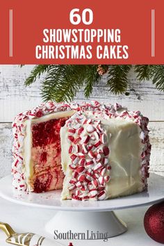 a christmas cake with white frosting and red sprinkles on the top