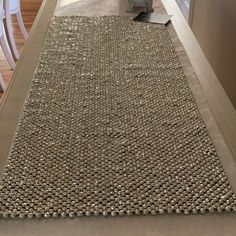 a large rug is on the floor in front of a dining room table and chairs