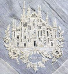 an embroidered piece of cloth with a castle on it