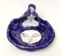 a blue plate with a woman's face in the center and stars on it