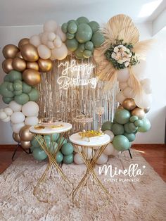 a table topped with two tables covered in balloons and confetti garlands on top of a shaggy rug