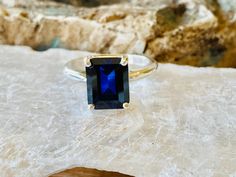 This classic 4 prong setting contains a beautiful 4.00ct. lab created emerald cut sapphire. The stone measures approximately 10x8mm. The ring is available in sterling silver, and 14k white, yellow, or rose gold. This ring makes a great promise or engagement ring. Please send me a message if you need a size not listed. All items are handmade by me in my shop in Woodbridge, NJ. Please message me with any questions. Shipping within the United States is complimentary. Thank you for exploring my shop Classic Radiant Cut Sapphire Ring, Emerald Cut Solitaire Sapphire Ring, Emerald Cut Sapphire Ring Gift, Radiant Cut Solitaire Sapphire Ring As Gift, Classic Sapphire Ring With Rectangular Stone, Emerald Cut Sapphire Ring Vs Clarity, Sapphire Solitaire Ring With Radiant Cut, Emerald-cut Sapphire Ring With Vs Clarity As A Gift, Emerald Cut Sapphire Ring With Vs Clarity As Gift