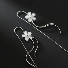 Add a touch of whimsy and elegance to your jewelry collection with these captivating cherry blossom flower dangle drop earrings. Crafted with solid 925 sterling silver, these earrings feature delicate white flowers and a unique wavy drop design that hangs beautifully from a threader. Give your loved one the gift of beauty and charm with these stunning earrings. Sold as a pairMaterials: 925 sterling silver, resinFinish: platinum plate Jewelry Care: See more information about how to care for your jewelry here. Shipping Policy: Orders will be shipped within 1-3 business days. Economy shipping will take 7-14 days to arrive and standard shipping is 1- 4 days for U.S. orders. International shipping time is depended on the country and per shipping method. Shipping cost will be calculated at check Spring Sterling Silver White Jewelry, Spring White Sterling Silver Jewelry, Delicate Sterling Silver Flower Earrings With Ear Wire, Elegant Sterling Silver Spring Jewelry, Elegant Sterling Silver Jewelry For Spring, Silver Minimalist Dangle Flower Earrings, Silver Dangle Flower Earrings Minimalist Style, Delicate Sterling Silver Linear Earrings, Elegant Sterling Silver Flower Earrings For Spring