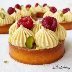 small desserts with raspberries and whipped cream on top are arranged in a circle