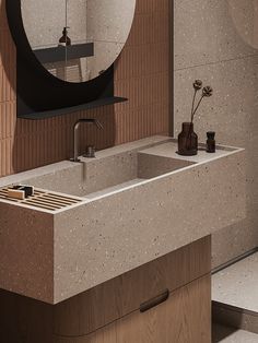 a bathroom sink with a mirror above it and a vase on the counter next to it