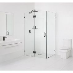 a bathroom with a toilet, sink and shower stall in it's own area