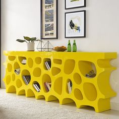 a yellow shelf with books and magazines on it