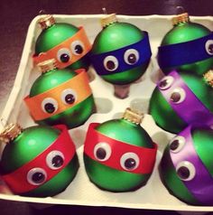 a box filled with lots of different colored christmas balls covered in googly eyeballs