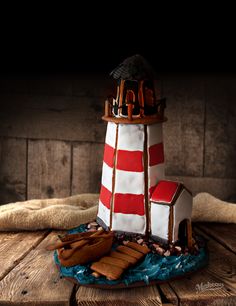 there is a cake made to look like a lighthouse with gingerbreads on it