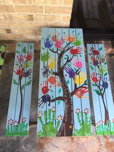 three handprinted wooden boards with trees on them