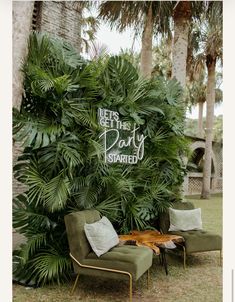 two chairs sitting in front of a palm tree with the words let's get that party started written on it