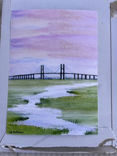 a watercolor painting of a bridge in the distance