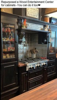 a kitchen with black cabinets and an oven on the counter top is seen in this instagramtion