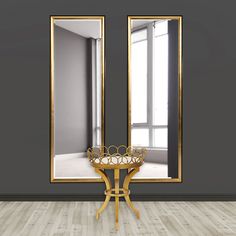 an empty room with two mirrors and a table